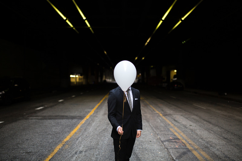 canva-businessman-holding-balloon-in-open-street-MACn6VqzODQ.jpg